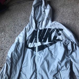 This is a grey and white nike windbreaker